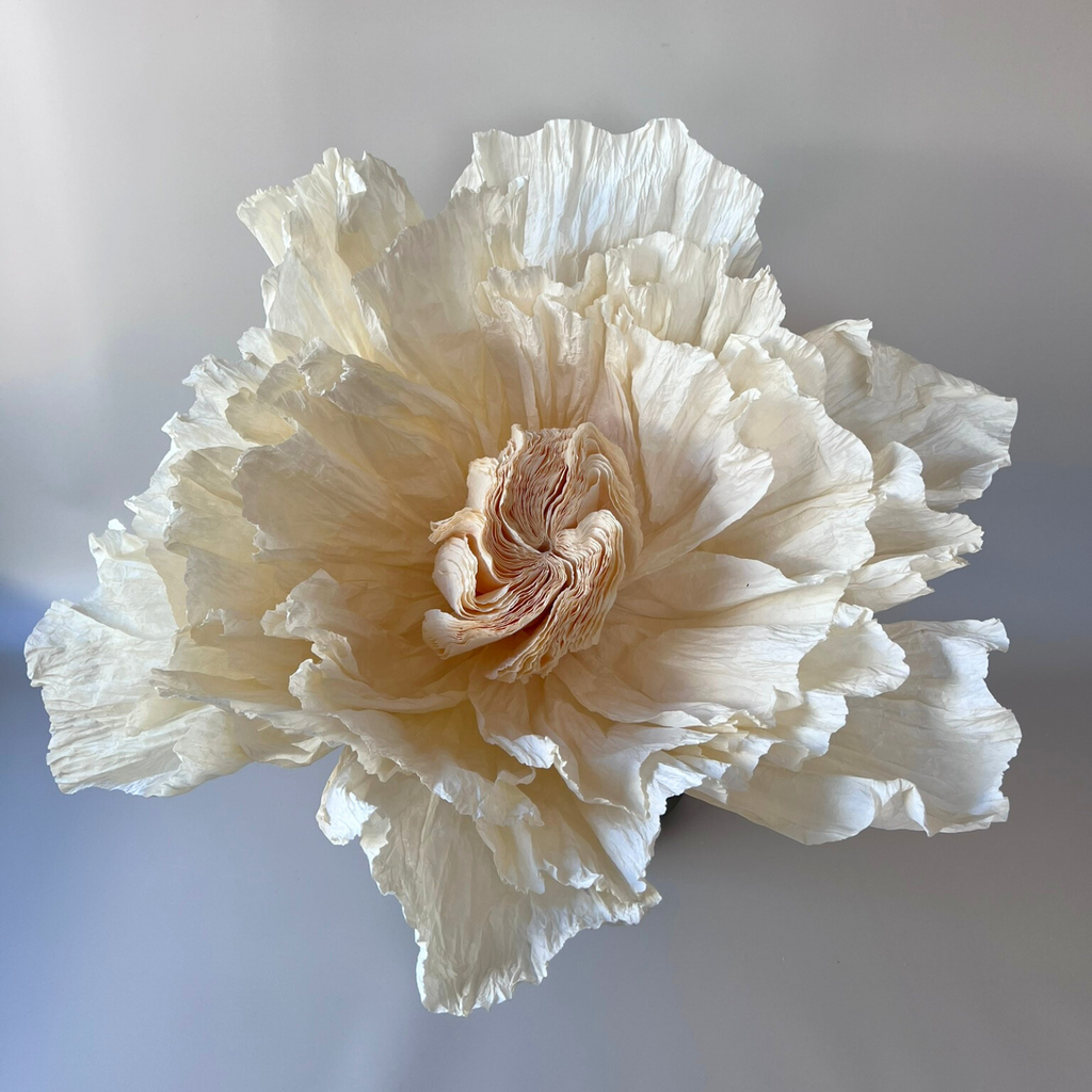 Close-up of a decorative giant peony flower made from ivory crepe paper