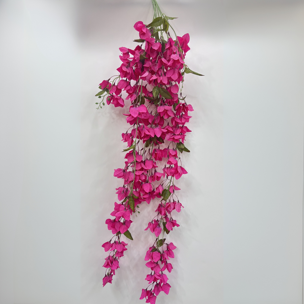 An Artificial pink Bougainvillea flower stem on a white background