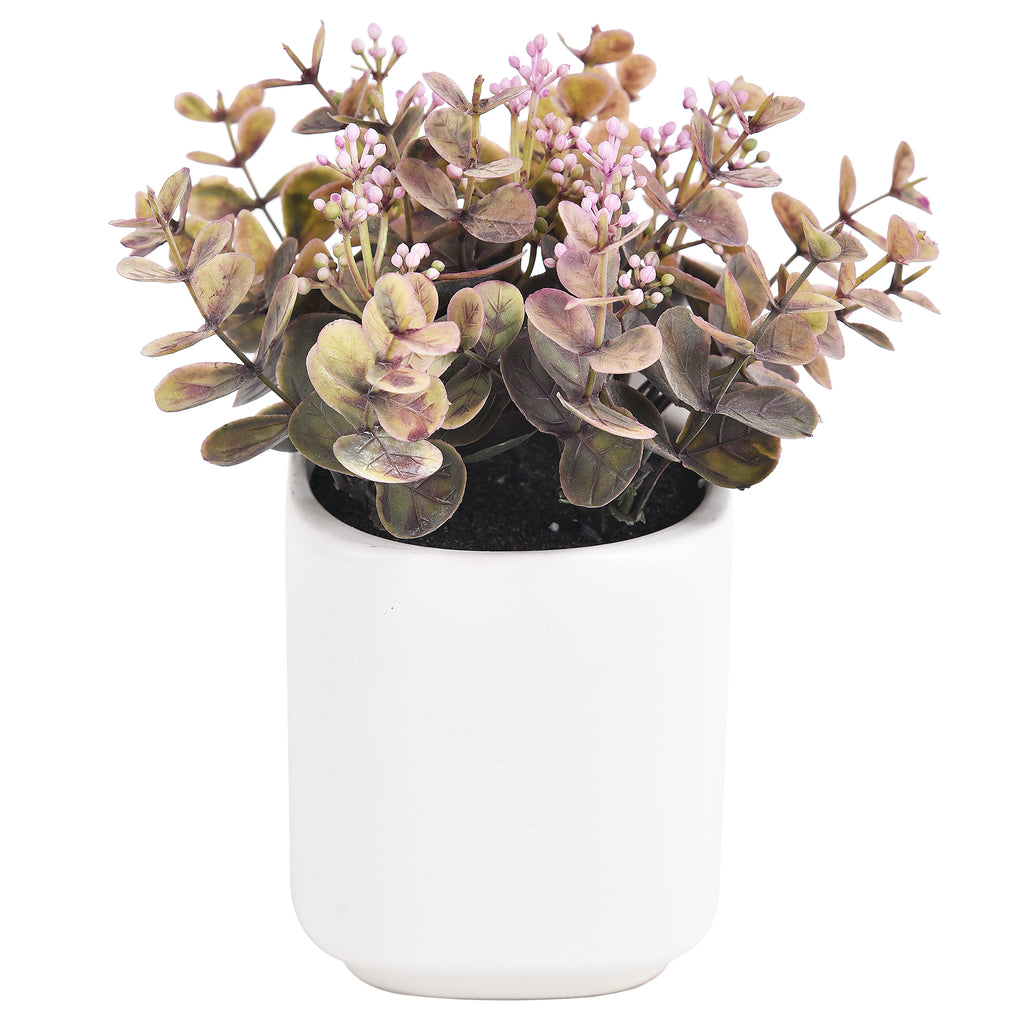 Artificial plant in a white pot on a white background