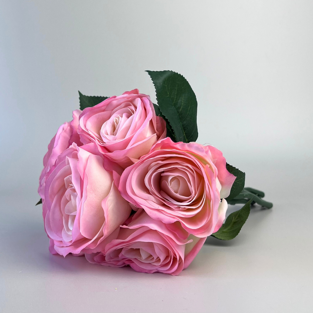 A beautiful bunch of 6 opening faux pink real touch roses with a tinge of white in the petals