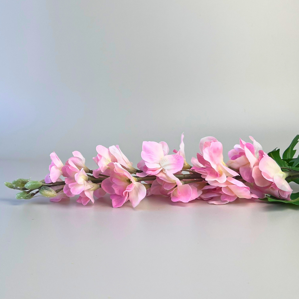 Pink artificial delphinium laid down