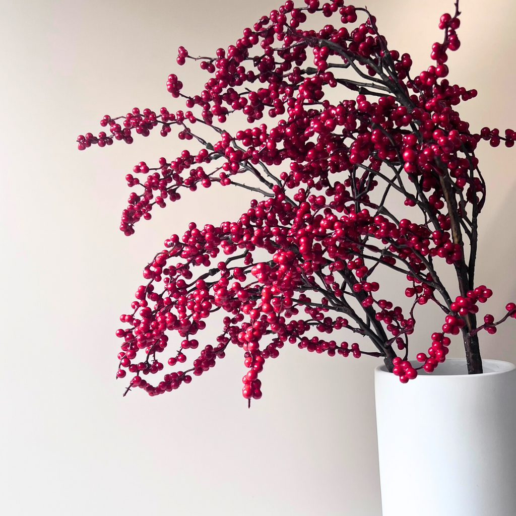 Vibrant red berries on the artificial large red lex branch