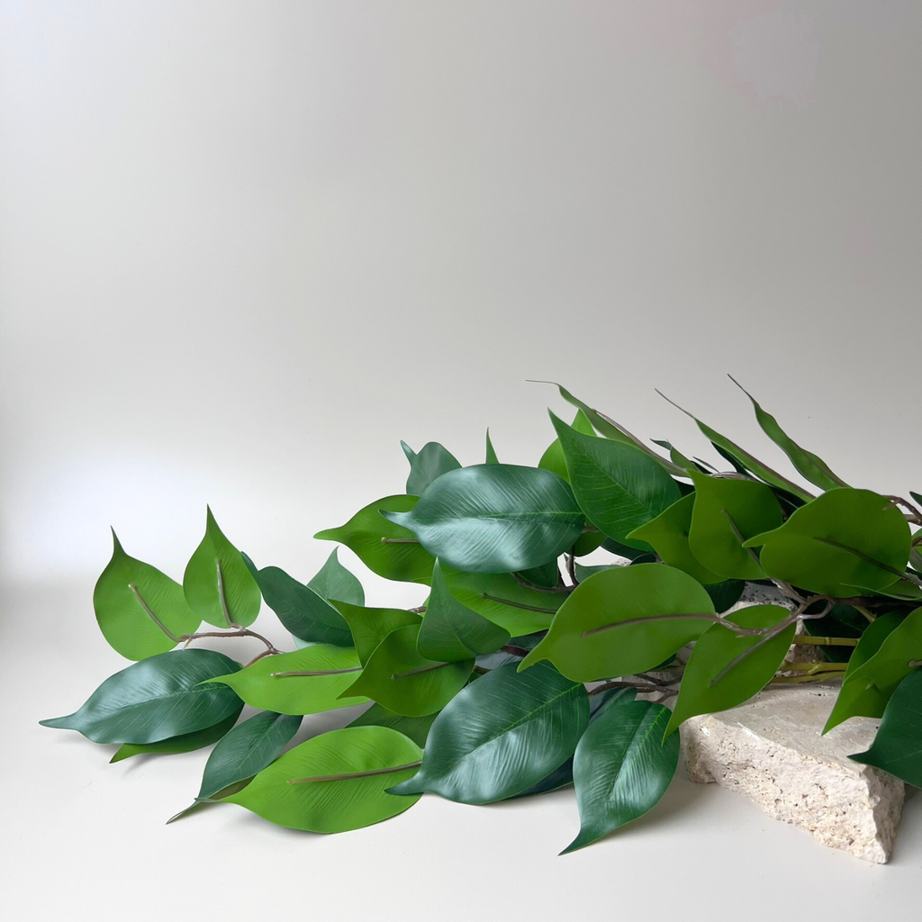 Eucalyptus faux branch displayed on cement block