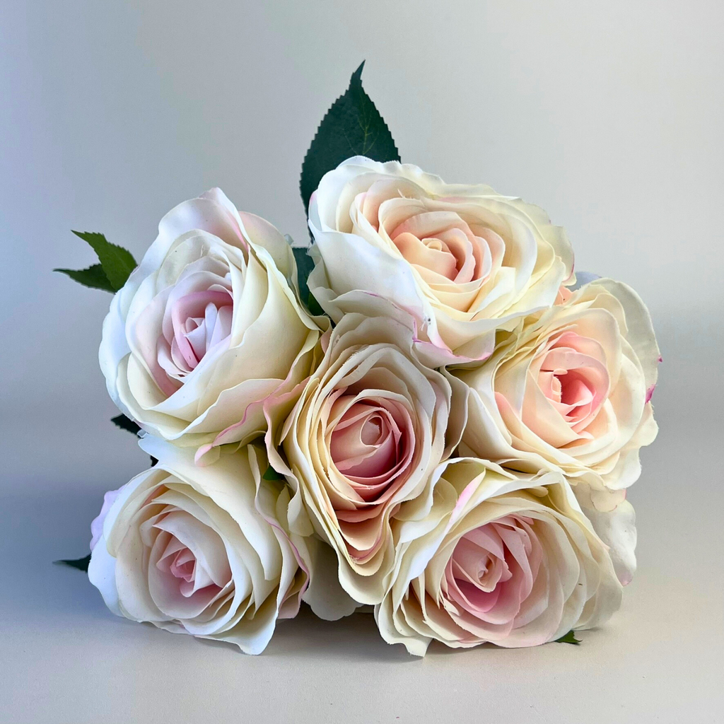 A bouquet of 6 real touch roses, ivory white with a touch of pink on the central petals.