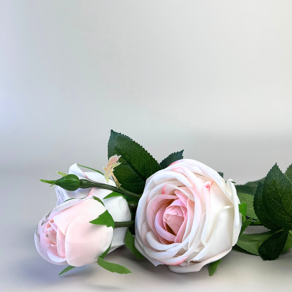 Artificial Real Touch Pink and white roses with green leaves on a light gray background