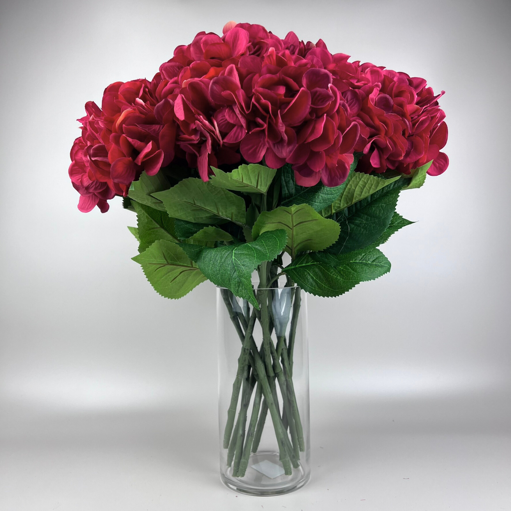 Styled cluster of red artificial hydrangea stems