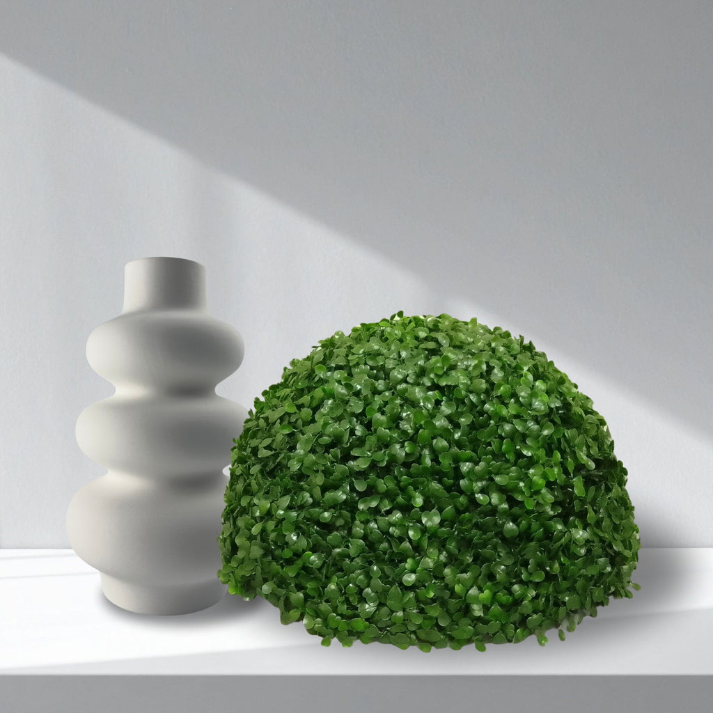 English Box Artificial Topiary Half Ball styled next to a white ceramic vase against a light grey background.