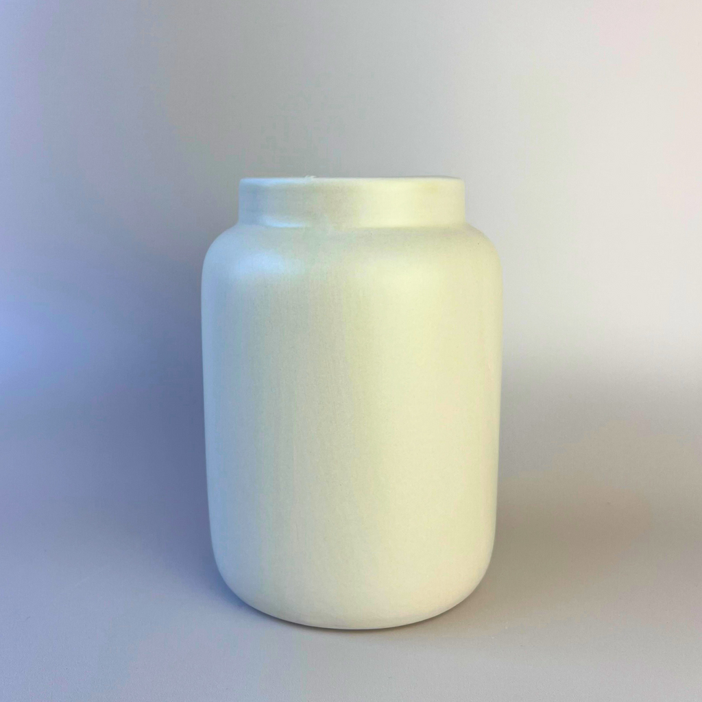 Close-up of stone-coloured ceramic rim vase on beige background