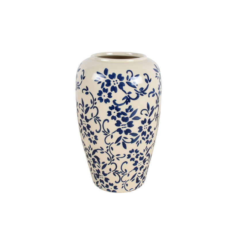 White ceramic vase with a timeless blue floral pattern against a white background