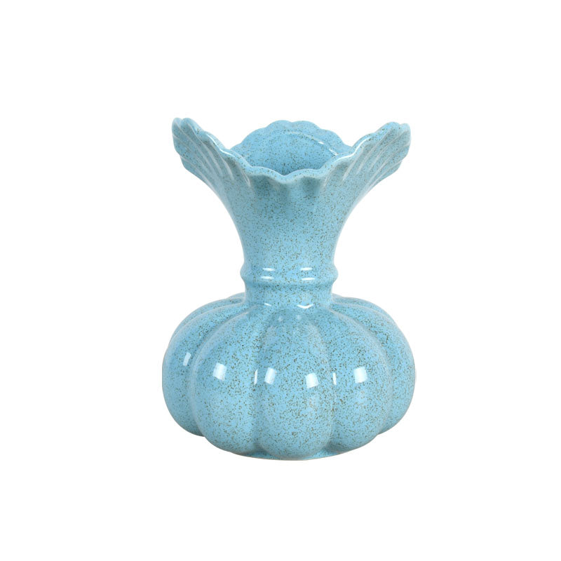 Light blue ceramic vase with a speckled matte finish against a white background

