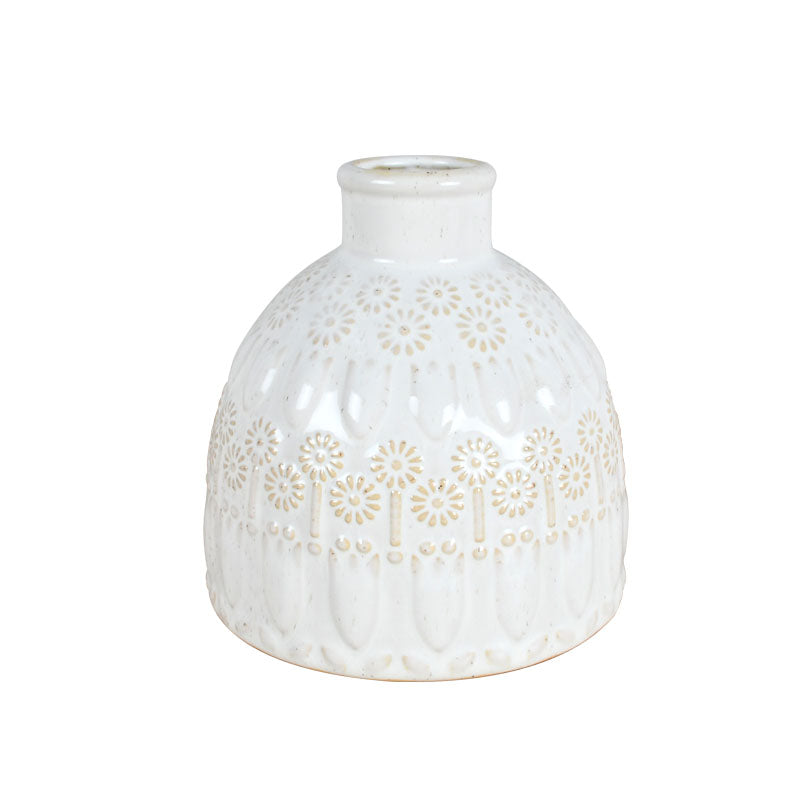 White ceramic vase with a delicate white pattern and glossy finish against a white background