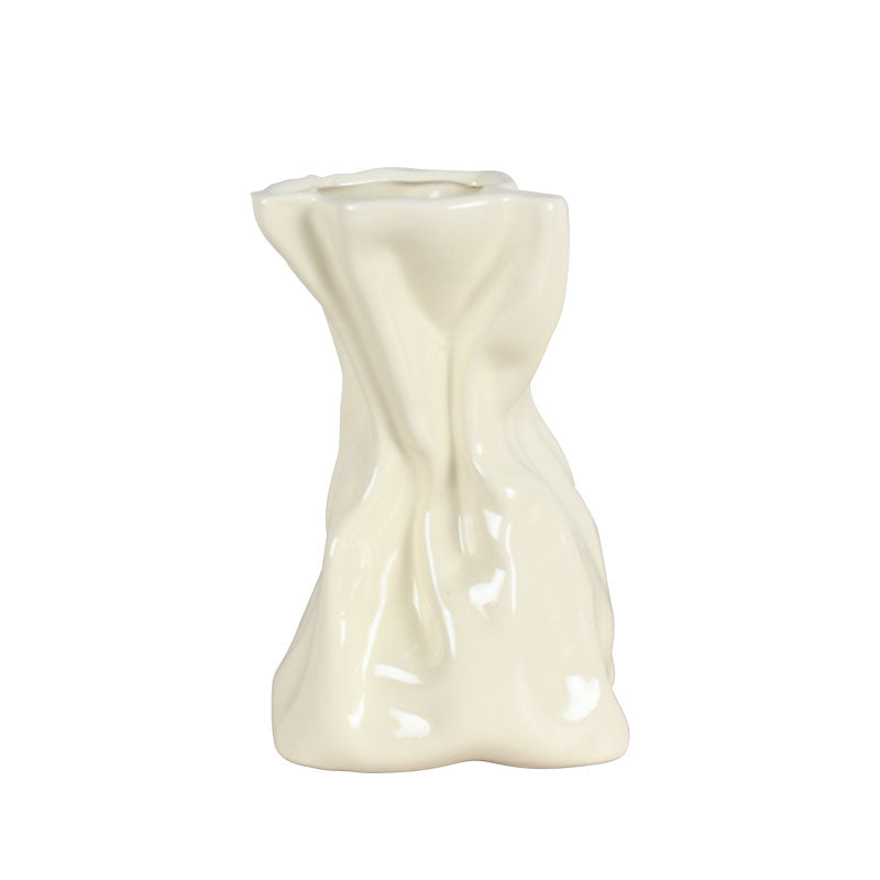 18cm cream ceramic vase with a unique, abstract form against a white background