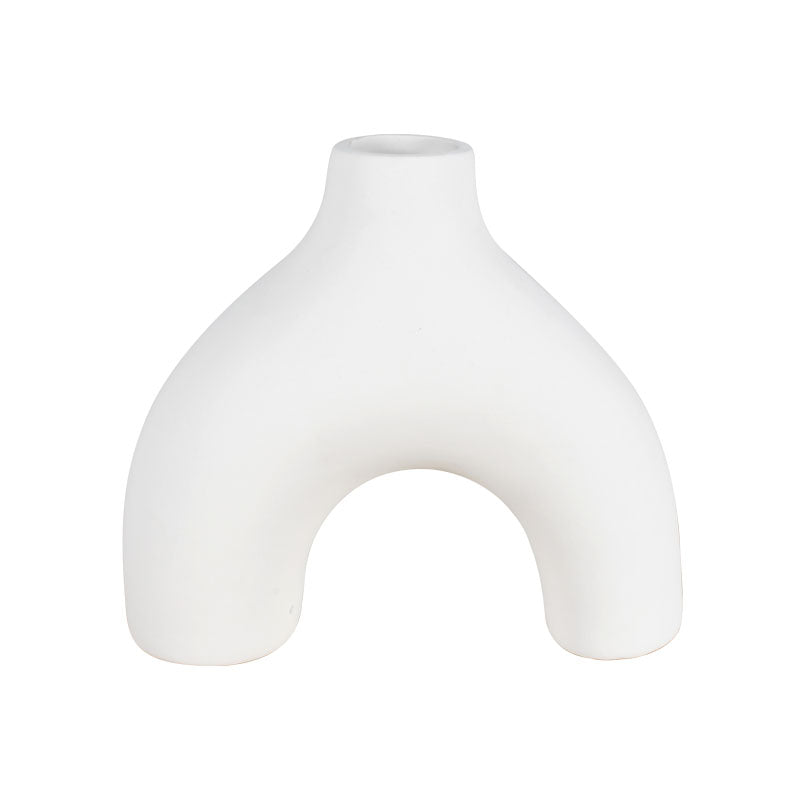 White arched ceramic vase against a white background